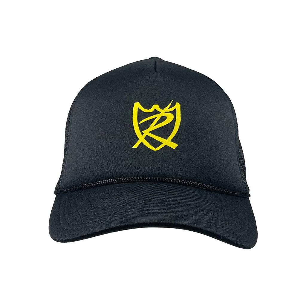 The S&M Rambler Sharpie Shield Cap is a black mesh-back hat with a yellow stylized shield and letter design on the front panel. It features an adjustable snapback closure for comfort, breathability, and a perfect fit.