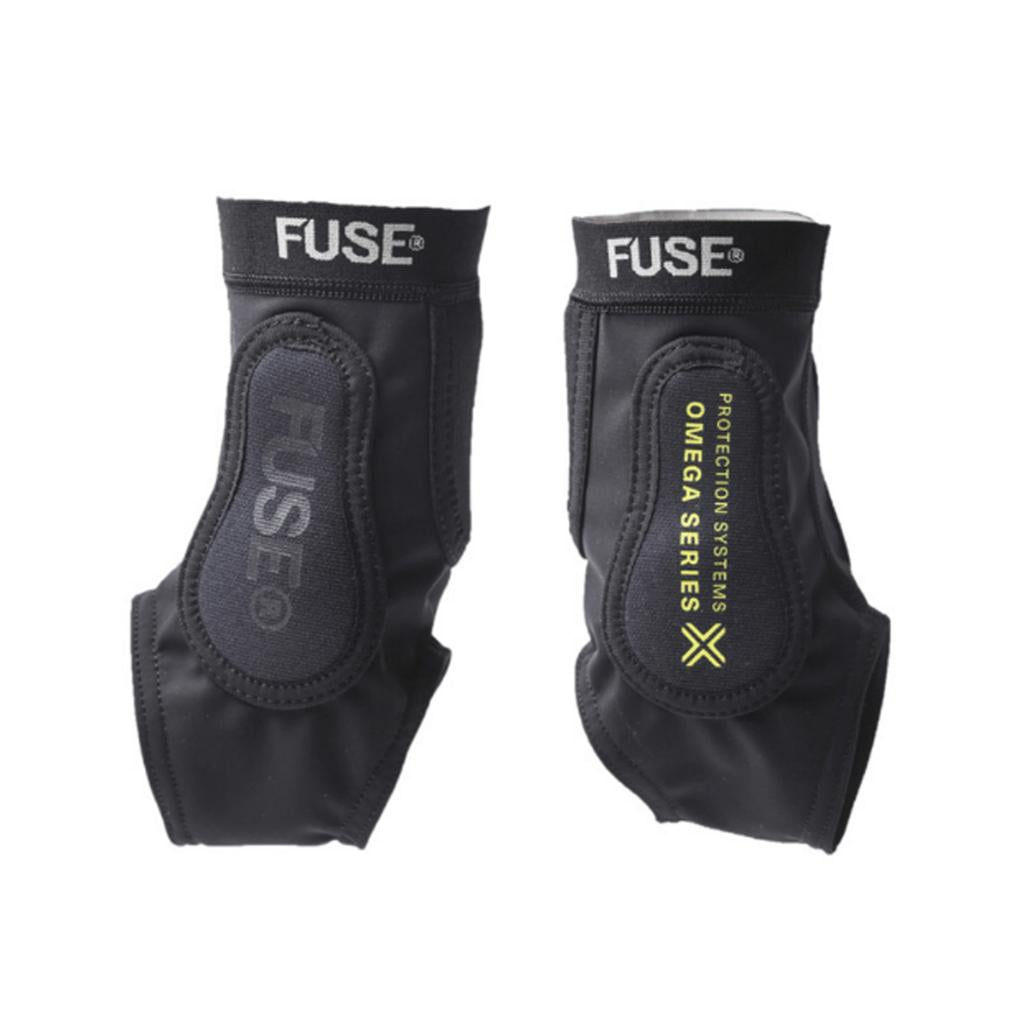 A pair of black Fuse Omega Pro Ankle Guards with padding, SAS-TEC impact protection, and "OMEGA SERIES PROTECTION SYSTEMS" printed in yellow on one guard.