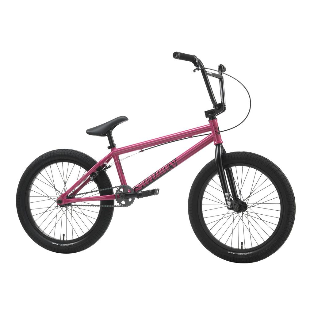 A Sunday Primer 20 Inch Bike in pink with black handlebars, seat, and Odyssey Springfield tires is displayed against a white background.