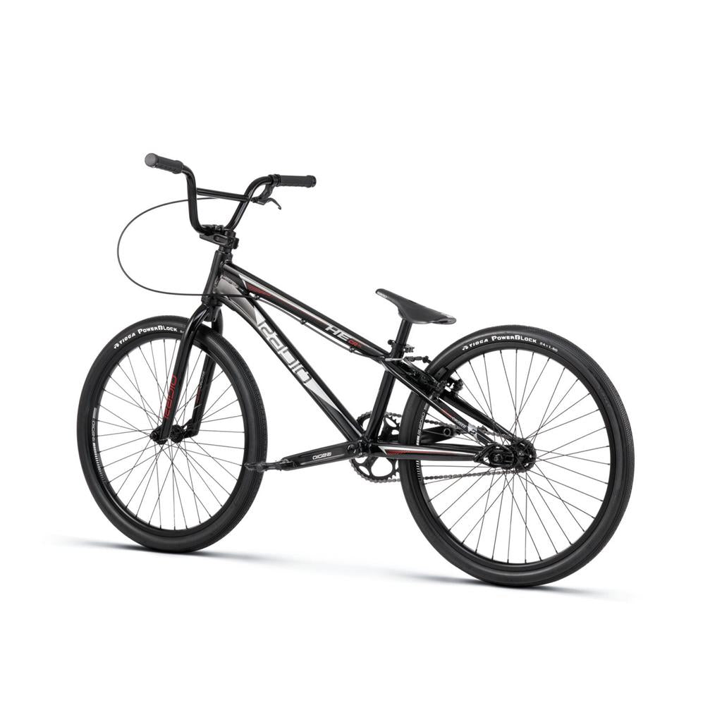 A black Radio Helium Pro 24 Inch Cruiser Bike with a lightweight frame, thick tires, and straight handlebars is photographed on a white background.