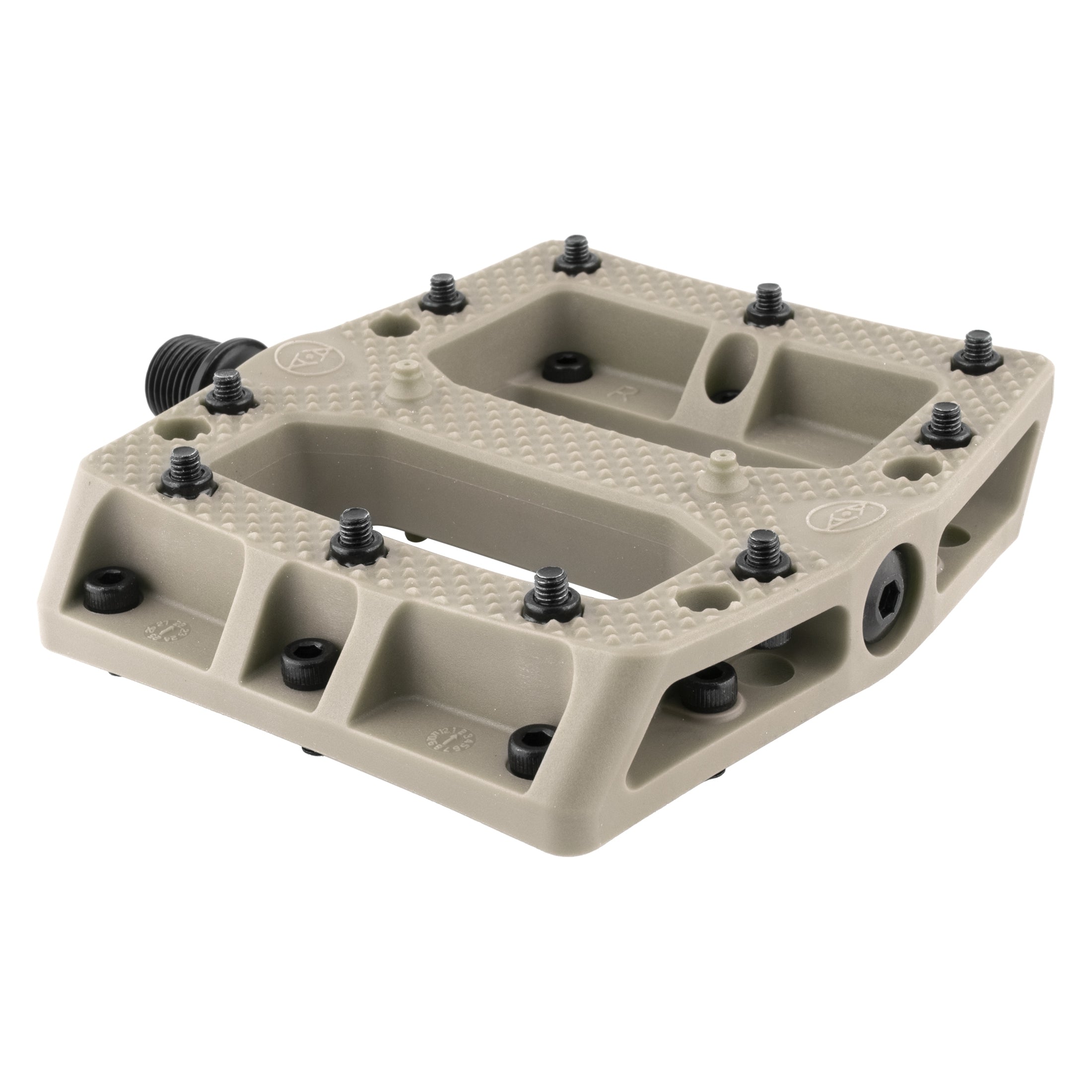 A close-up of the Alienation Foot Fetish Pedal, a flat beige platform pedal featuring a textured surface and multiple black traction pins for enhanced grip.