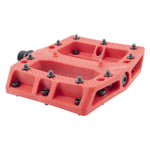The Alienation Foot Fetish Pedal features a red thermoplastic body with a textured surface and multiple metal grip pins, designed for standard bike cranks, shown against a white background.