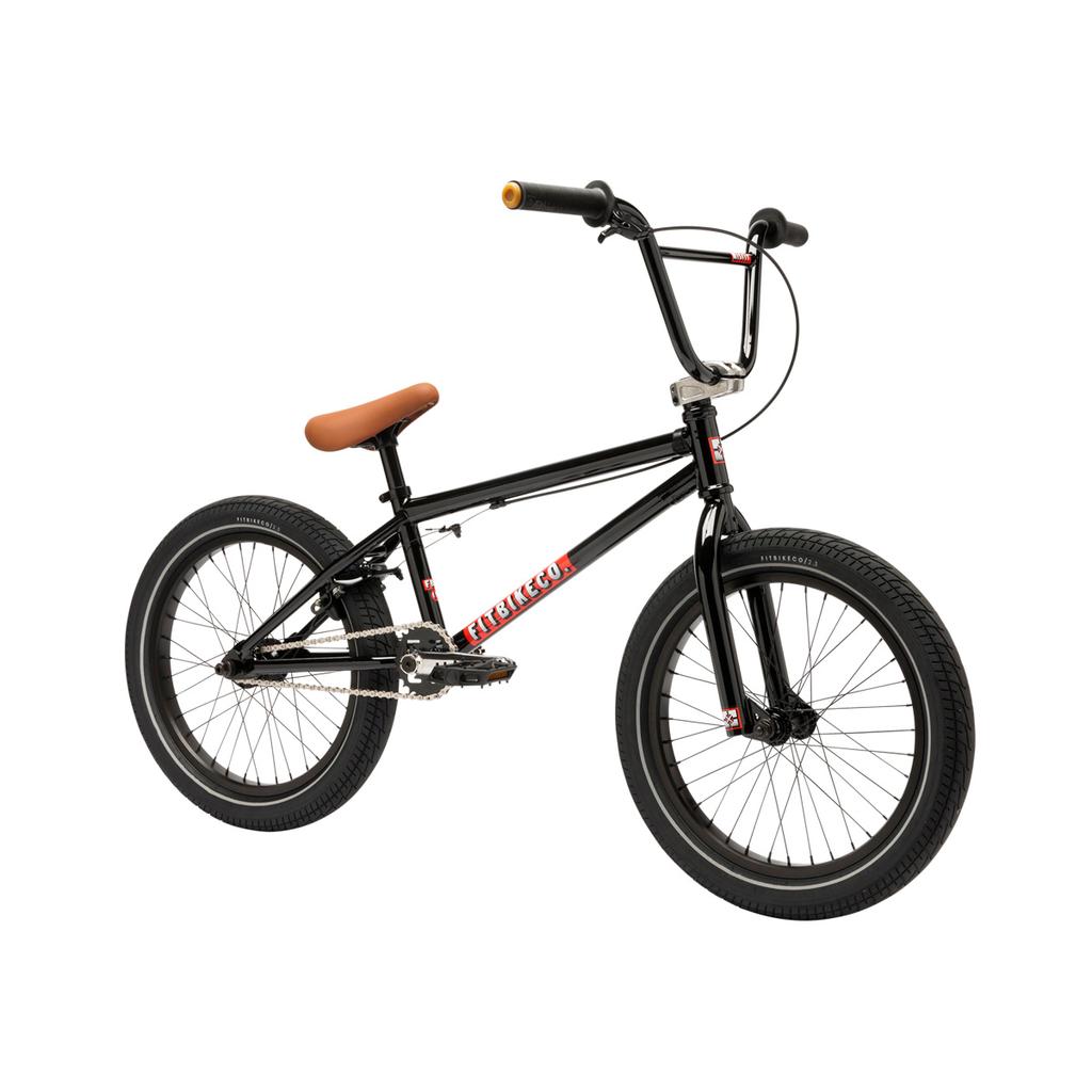 A Fit Bike Co Misfit 18 Inch youth BMX bike in black with a brown seat, thick tires, and a gold accent on the right handlebar grip, displayed on a white background.