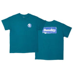 The Sunday Sticker T-Shirt is a teal short-sleeve tee with a small circular Sunday Sticker logo on the chest and a large white "Sundays" graphic in a blue rectangle on the back.