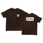 The Sunday Sticker T-Shirt features a small circular "S" logo on the front and bold "Sunday Sticker" text in a white rectangular box on the back—a dark brown tee perfect for your weekend sessions.