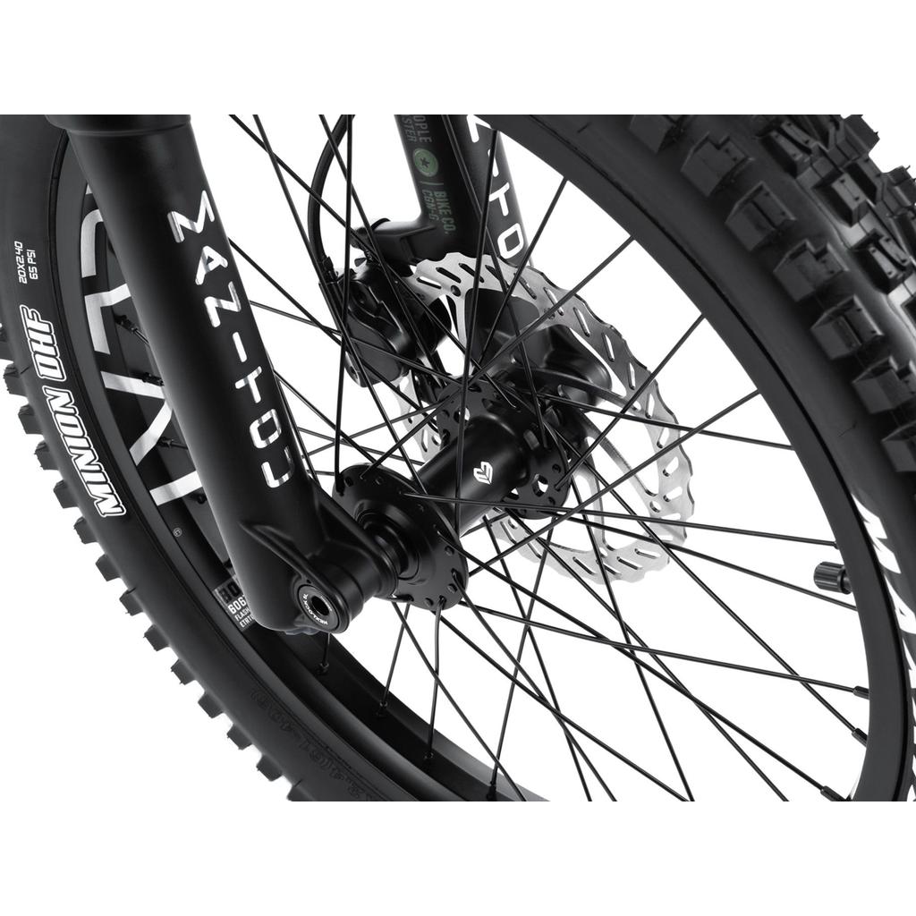 Close-up of a Wethepeople Swampmaster 20 Inch Bike front wheel featuring a suspension fork, disc brake, and knobby tire.