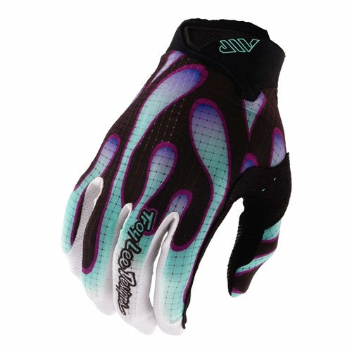 The TLD 26.1 Air Glove in Overspray Black/Real Teal features a black base with teal and purple flame-like patterns, white fingertips, ergonomic fit for comfort, and touchscreen compatibility. Shown from the top view.