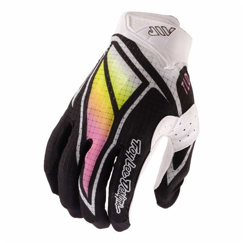 The TLD 26.1 Air Glove / Proton Black is a black and white mountain bike glove with a pink and yellow gradient, ergonomic fit, and "Troy Lee Designs" on the index finger for both style and function.