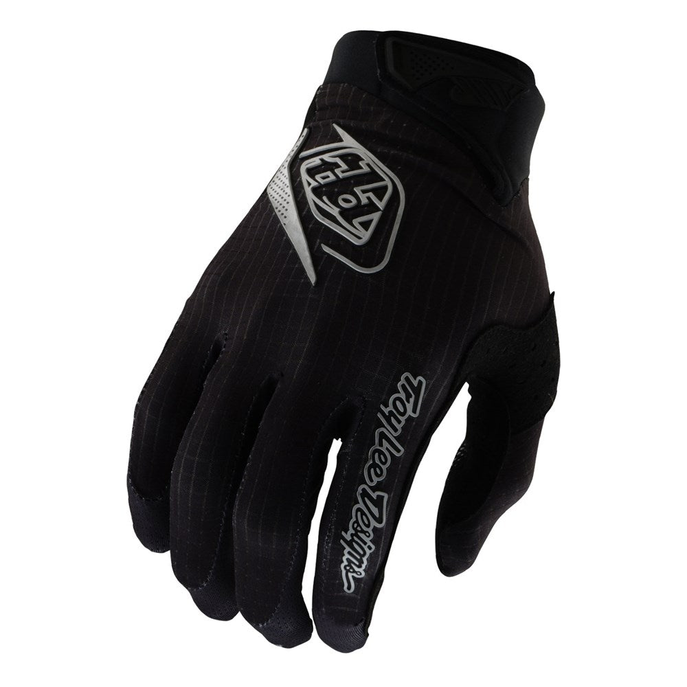 The TLD 25.1 Air Glove Mono Black features white lettering with a logo on top and "Troy Lee Designs" on the index finger. It provides reinforced knuckles, a sleek design, and micro-mesh ventilation for superior comfort and breathability.