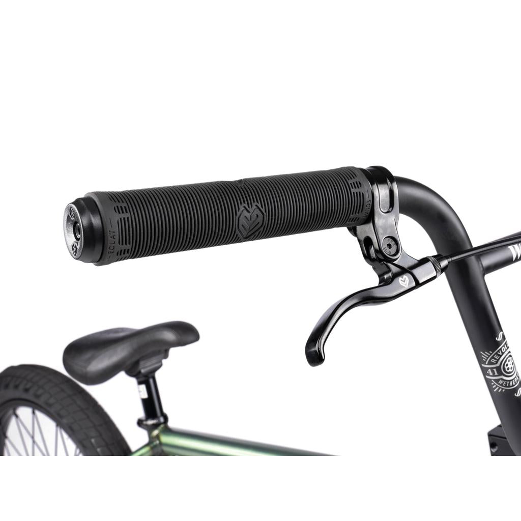 Close-up of a Wethepeople Revolver 20 Inch Bike’s black handlebar grip, brake lever, and seat against a white background. Features high quality aftermarket parts for enhanced performance and style.