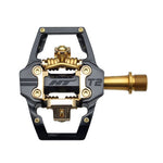 A top view of the HT Components T2Ti Pedals, Limited Edition Gold: a lightweight black and gold mountain bike pedal featuring a flat platform and clip-in mechanism.