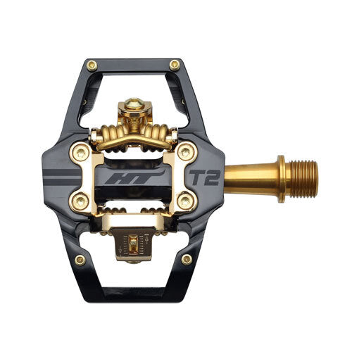 A top view of the HT Components T2Ti Pedals, Limited Edition Gold: a lightweight black and gold mountain bike pedal featuring a flat platform and clip-in mechanism.
