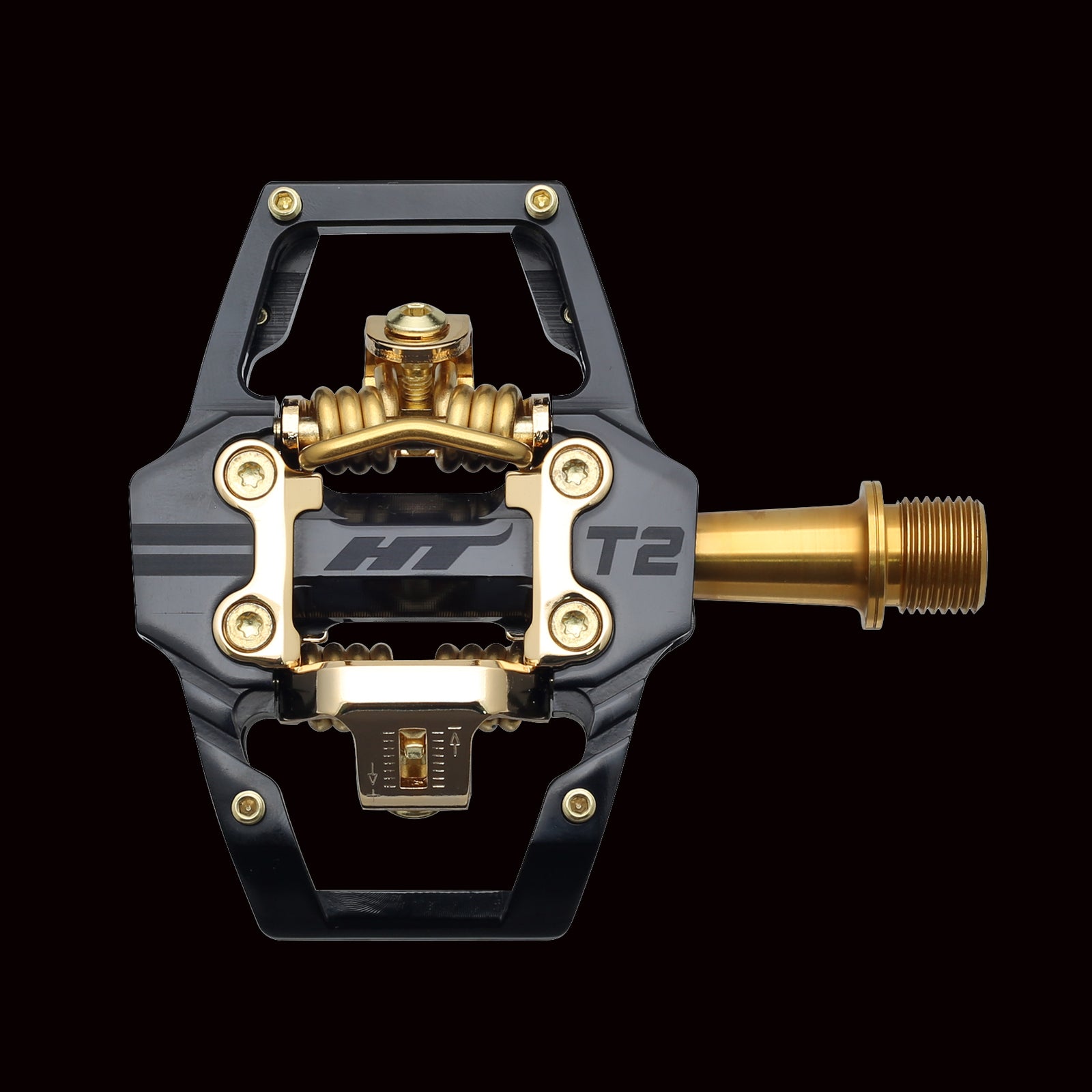 The HT Components T2Ti Pedals, Limited Edition Gold, feature a black and gold metallic finish and are shown from above against a plain black background—ideal for cyclists seeking lightweight pedals with premium style.