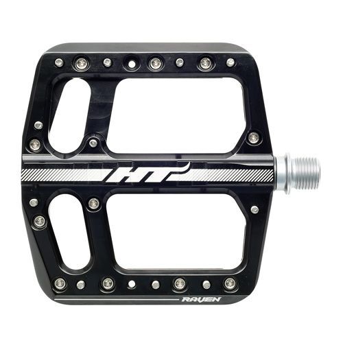 The HT Components ANS12 Raven Pedals are black flat aluminum mountain bike pedals with metal pins, a silver spindle, and "HT" and "Raven" displayed on the large platform.