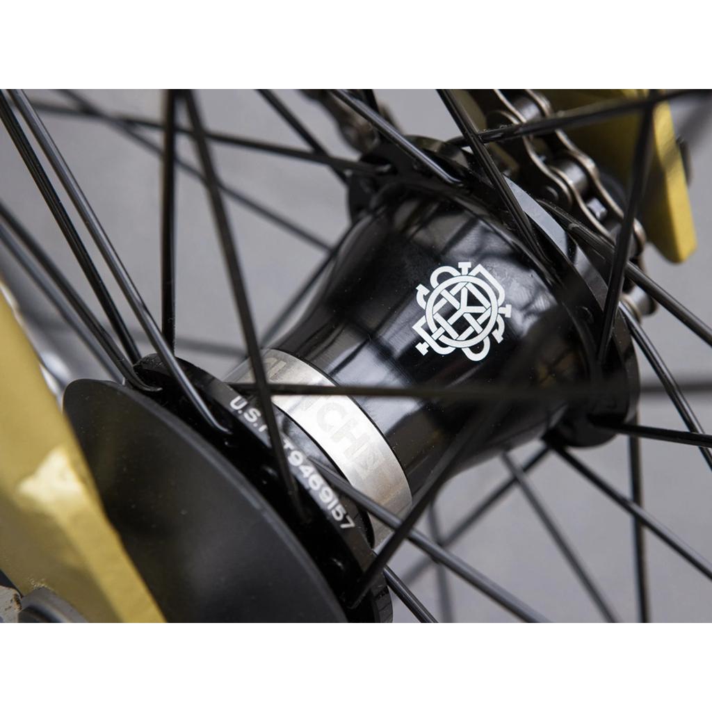 Close-up of the Sunday Forecaster 20 Inch Bike (2025) / Broc Raiford hub with white logo and spokes, plus gold forks, rear cog, and an Odyssey Clutch v2 Freecoaster.