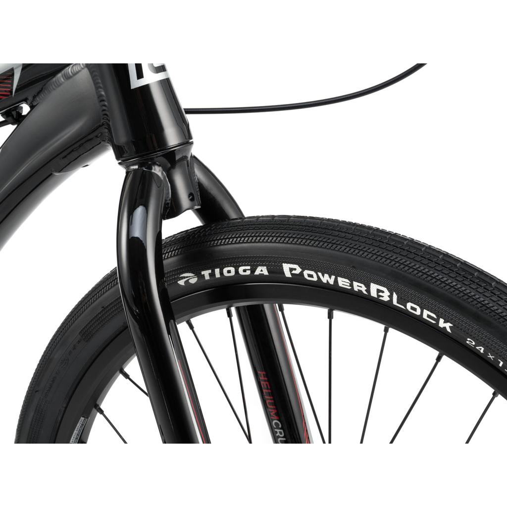 Close-up of a Radio Helium Pro 24 Inch Cruiser Bike front fork and wheel fitted with a Tioga PowerBlock tire, highlighting the detailed tread pattern and visible branding.