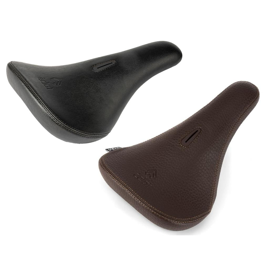 Two Eclat Exile Pivotal Seats, one black and one brown, are displayed on a white background. Each features a textured surface and a central ventilation slot, blending comfort and style in an ergonomic bicycle seat design.