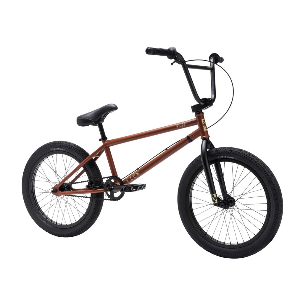 The Fit Bike Co Flow 20 Inch Bike features a BMX-inspired matte brown frame with black handlebars, seat, and wheels—ideal for riders wanting the signature style of the Flow series. Shown against a white background.