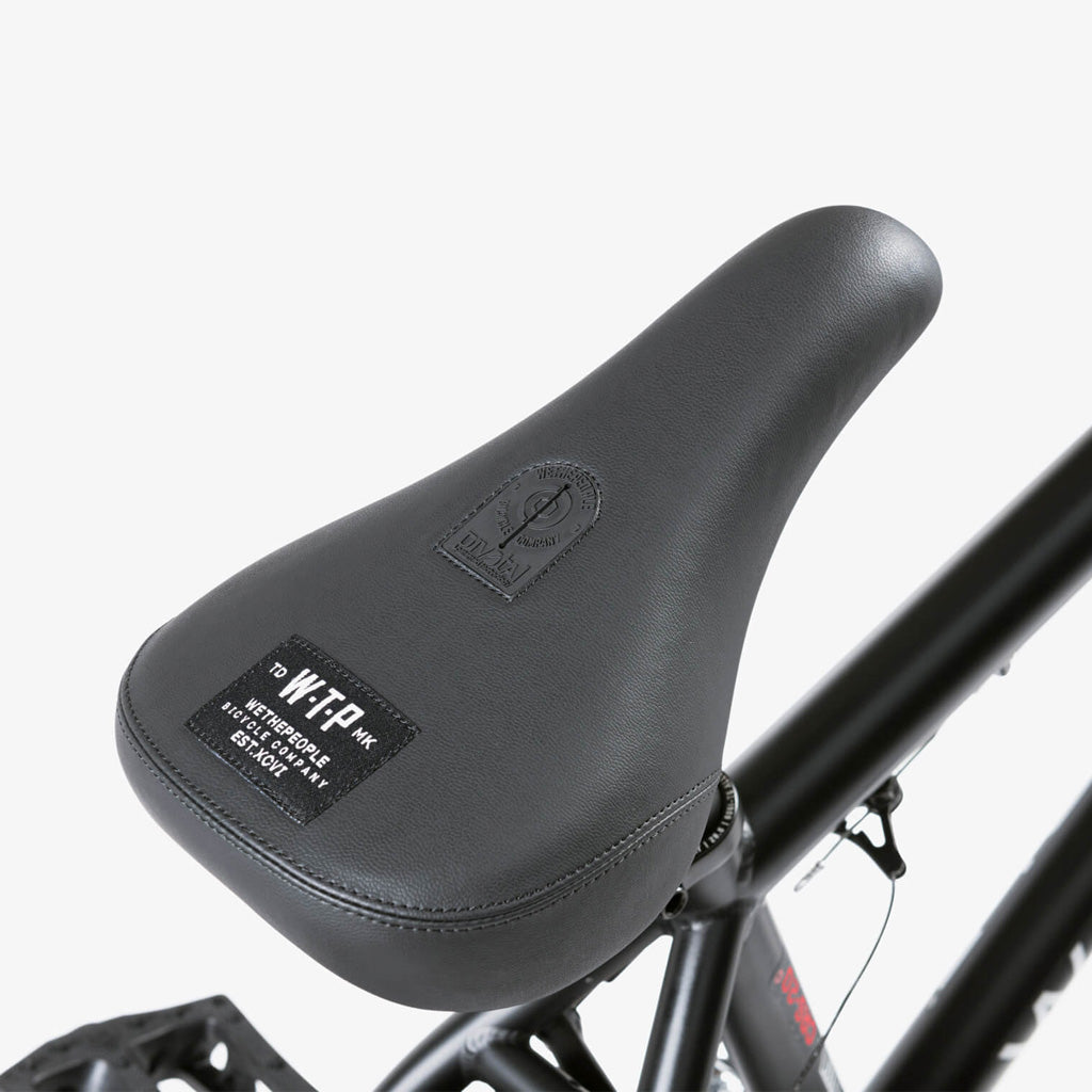 A close up of a black bicycle seat featuring the Wethepeople CRS 20 Inch Bike.