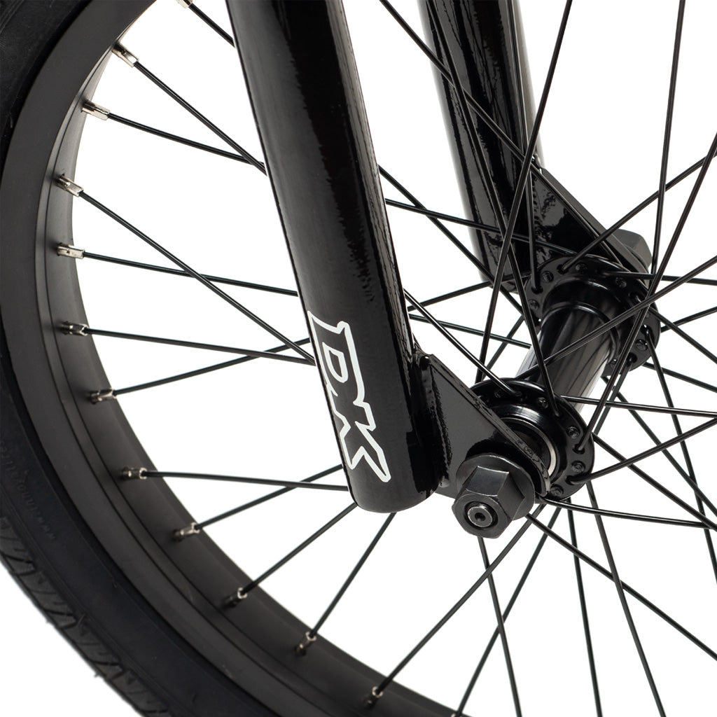 A close up of a black 18 inch BMX wheel on a DK Aura 18 Inch Bike.