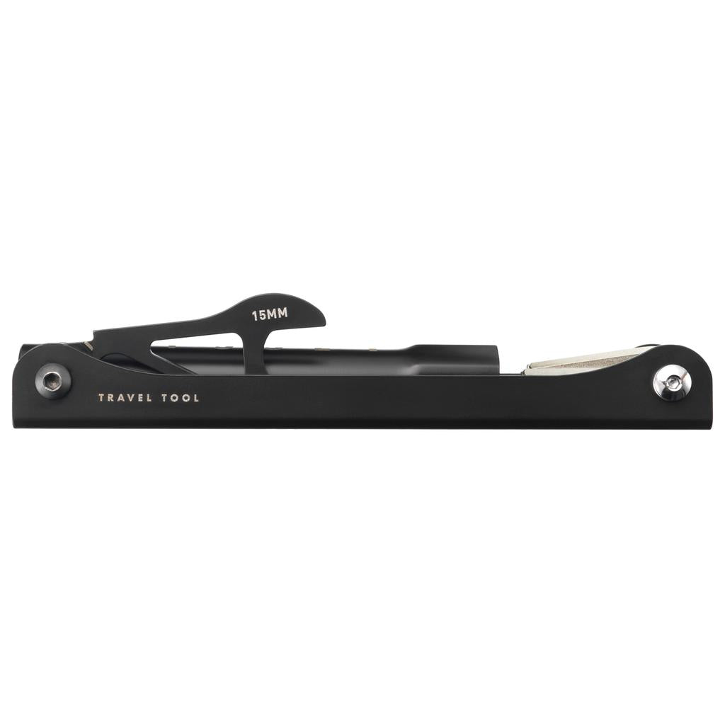 A black Odyssey Travel Multi Tool featuring a 15mm pedal wrench and a compact, flat design, shown from the side against a white background.