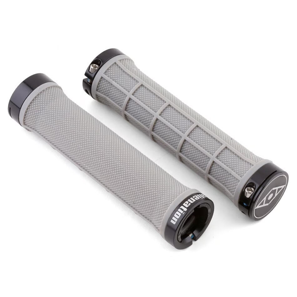 Two gray Alienation Moto Lock-On Grips with textured surfaces made from super soft Kraton, each featuring black lock-on rings at both ends, displayed on a white background. Inspired by classic motocross grips, these are designed for comfort and secure handling.