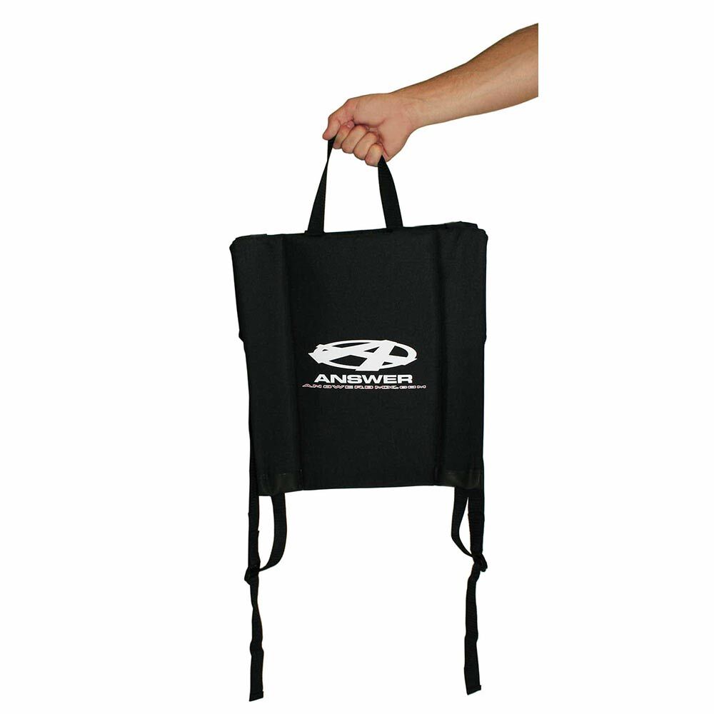 A hand holding the black Answer Stadium Seat with adjustable straps and the "Answer" logo on the front—ideal for carrying your BMX racing essentials.