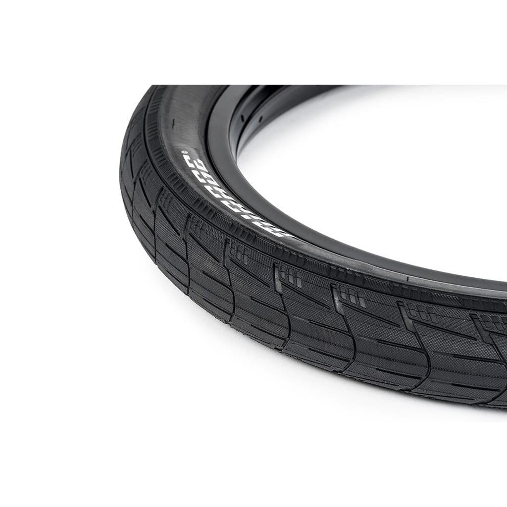 Close-up of a black Eclat Mirage Folding Tyre, highlighting its textured tread pattern and high-performance 120tpi casing, set against a white background.