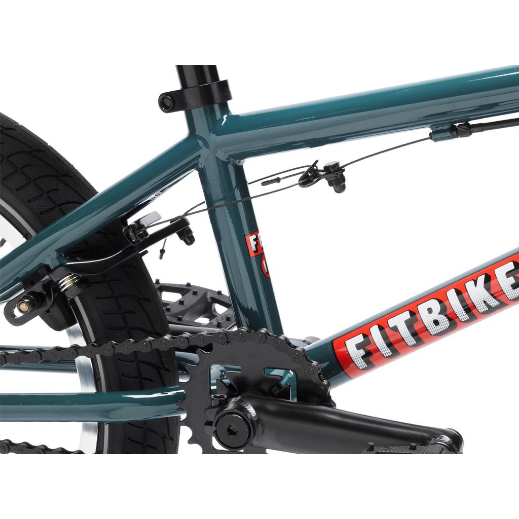 Close-up of a teal Fit Bike Co Misfit 16 kids BMX bike frame, highlighting the chain, rear brake cable, part of the rear wheel, a "Fitbike" logo on the frame, and a sealed integrated headset for smooth steering.