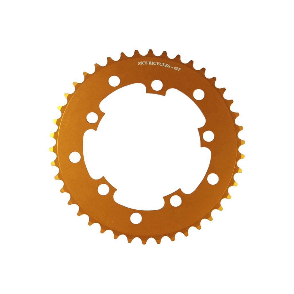 The gold MCS 110BCD 5 Bolt Chainring features 47 teeth, multiple bolt holes, and fits BMX bikes with its evenly spaced edge design.