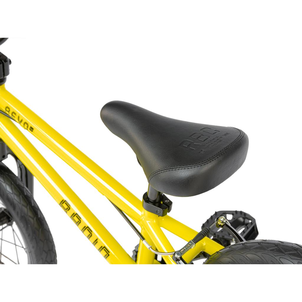 Close-up of a black seat on a yellow Radio Revo 14 Inch bike frame, with rear wheel and pedal visible—ideal for a first BMX bike.