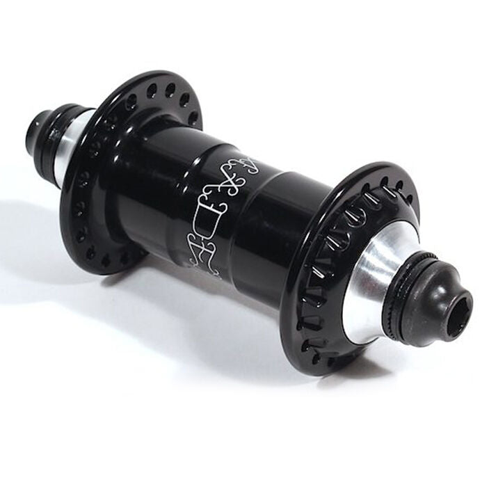 The Madera Pilot V2 Front Hub, featuring a black and silver finish, multiple spoke holes, and sealed end caps, is shown resting on a white surface.