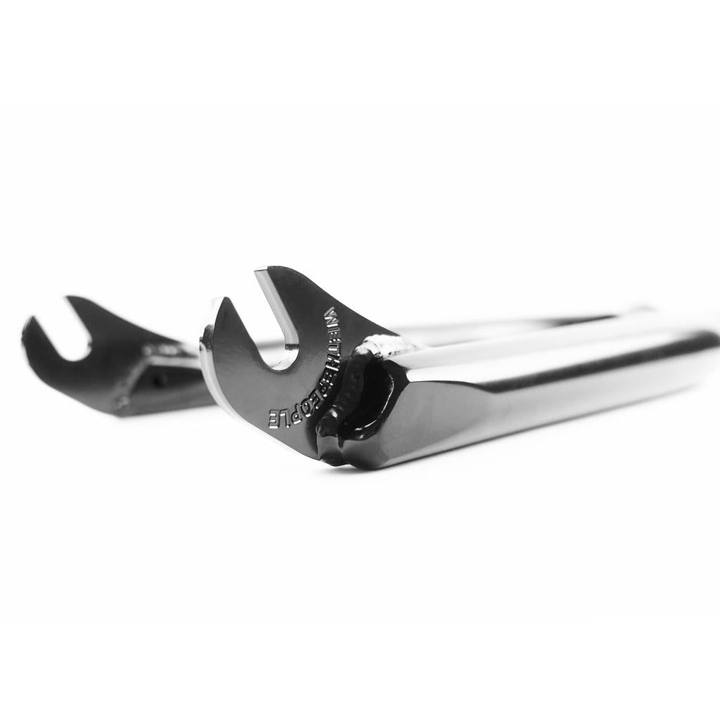 Two chrome open-end wrenches lie on a white surface, their sharp focus and precision evoking the craftsmanship of the Wethepeople ARC Fork, the Murray Loubser signature BMX fork.