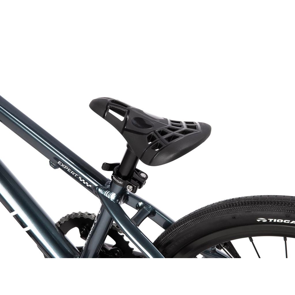 Close-up of the geometric cutout seat on the Radio Xenon Expert Disc 20 Inch Bike, featuring a lightweight alloy frame in metallic blue, with part of the rear tire visible.