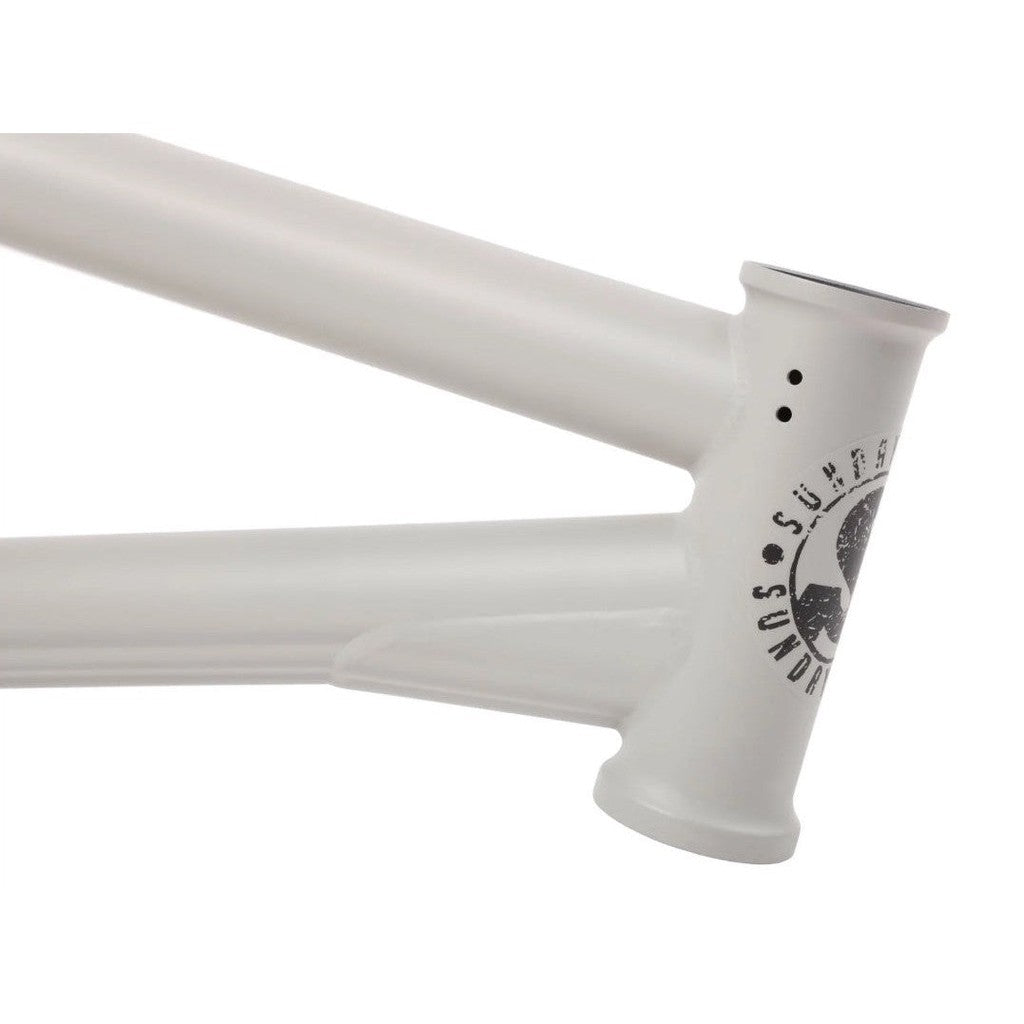 A white bicycle frame with a Sunday Wavelength Frame logo on it.