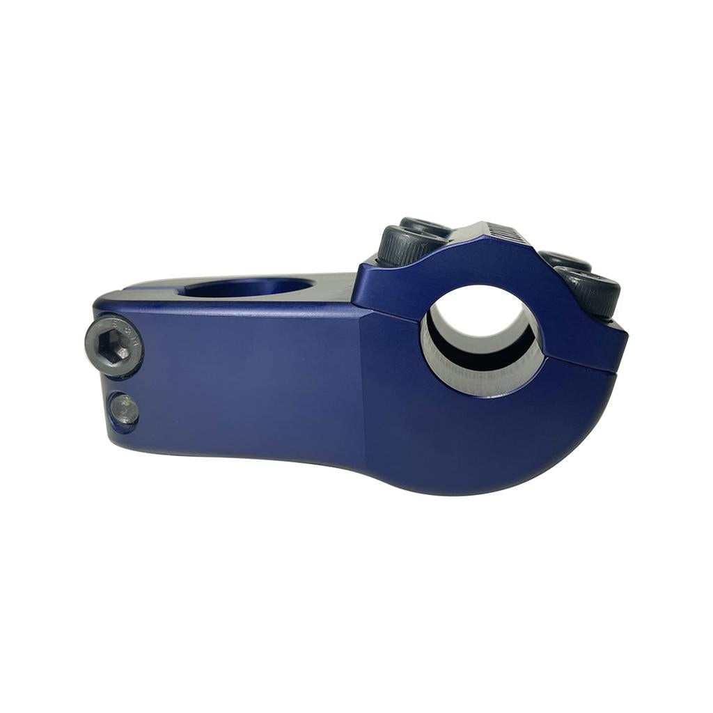 The S&M Turtleneck Stem is a blue metal BMX stem with a 52mm reach, multiple bolt holes, and a clamp for handlebars, shown against a white background. Inspired by the classic S&M Credence Turtleneck design.