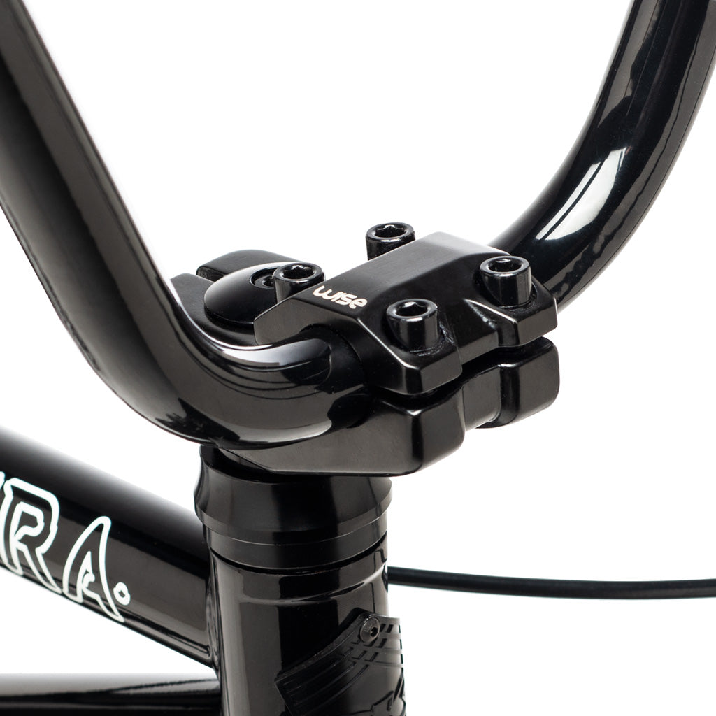 A close up of a black DK Aura 18 Inch Bike, a smaller shredder from the 18-inch wheel category, with handlebars.