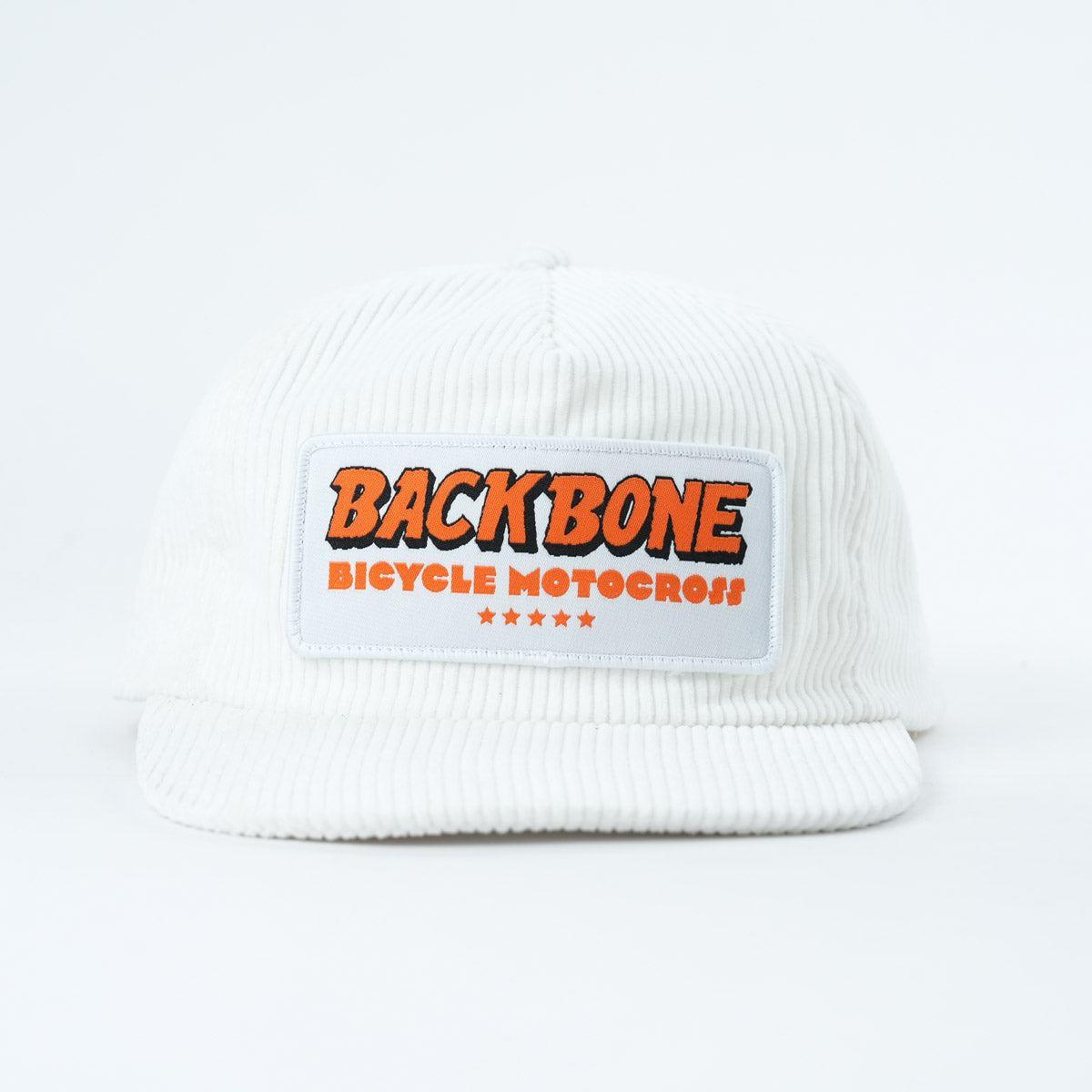 The Backbone 5 Star Snapback Hat is a white corduroy 5-panel cap with a front patch that says "BACKBONE BICYCLE MOTOCROSS" in orange and five small red stars beneath—ideal for any Backbone BMX fan.