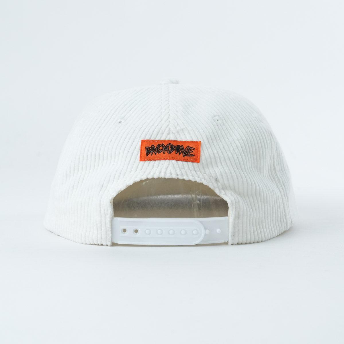 The Backbone 5 Star Snapback Hat is a white corduroy 5-panel cap with an adjustable strap and an orange patch featuring black "BACKBONE" text—an ideal accessory for any Backbone BMX fan.