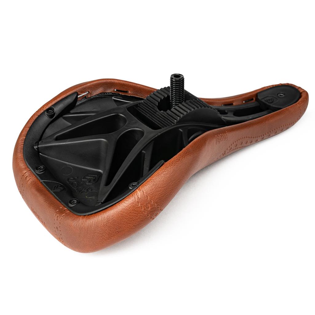 The Eclat Exile Pivotal Seat / Tyson is shown upside down in brown, revealing its black plastic base and mounting hardware.
