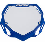 The Box Two Phase 1 Number Plate Large is a blue and white rectangular BMX number plate with the word "BOX" Component at the top, featuring cut-out corners and four attachment points, ideal for Phase 1 plate competitors.