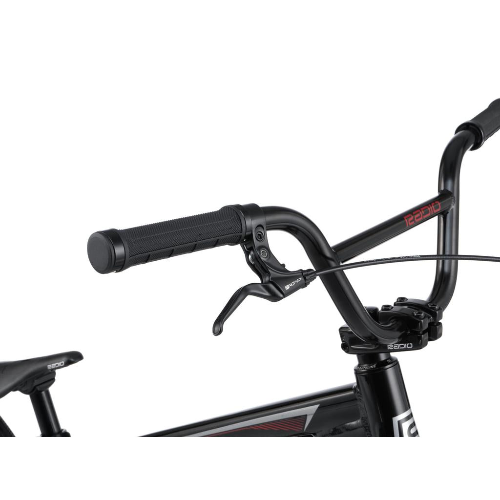 Close-up of the right handlebar and brake lever on a black Radio Helium Pro 24 Inch Cruiser Bike with "RADIO" branding on the top tube.