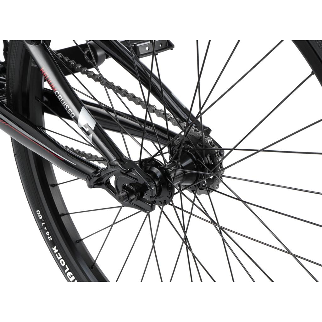 Close-up of the rear wheel on a Radio Helium Pro 24 Inch Cruiser Bike, featuring spokes, chain, gears, and part of the tire against a white background.