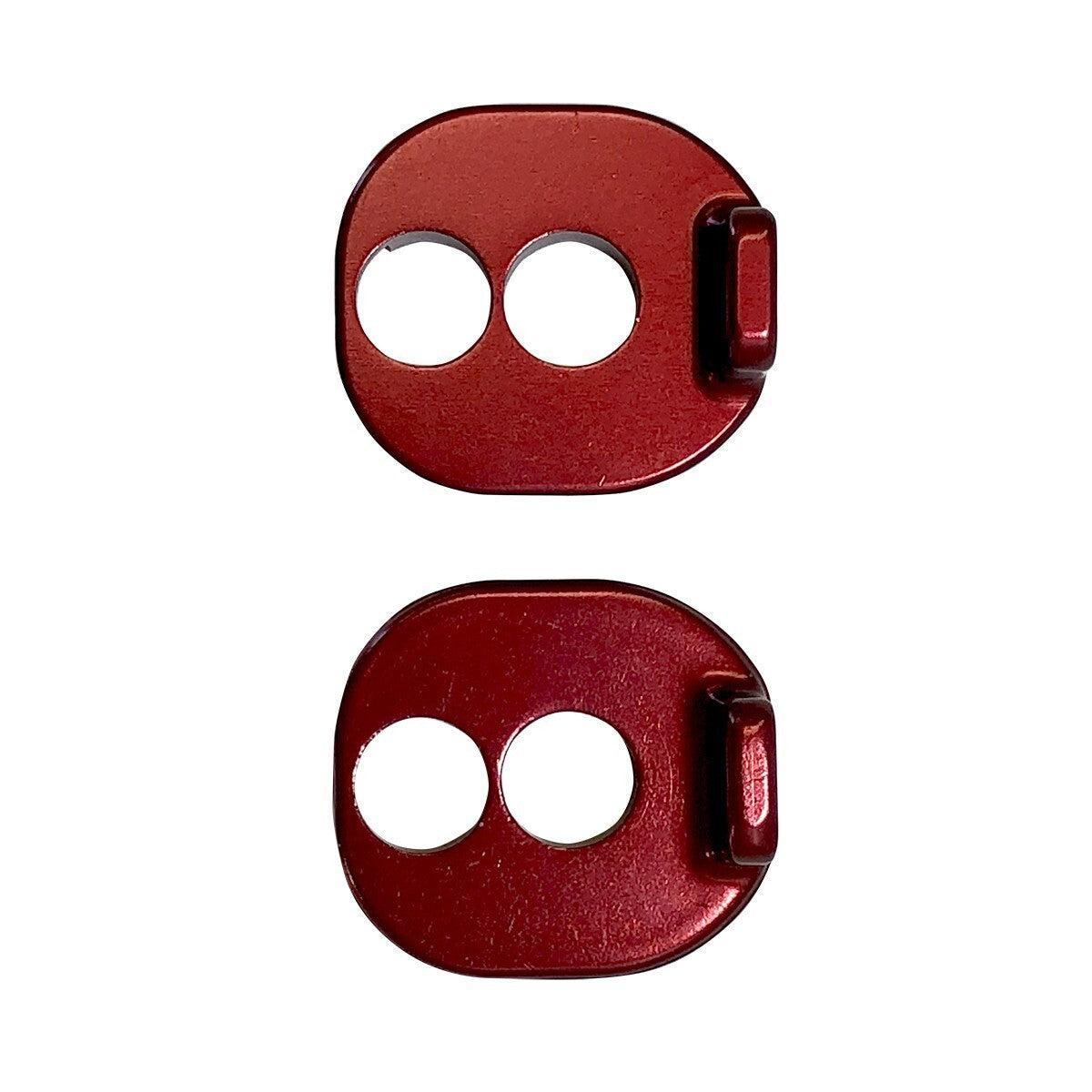 Two small, red, metal objects—identified as Chain Tensioner Kit for ACT Frame—with two round holes and a raised tab on one side, shown against a white background.