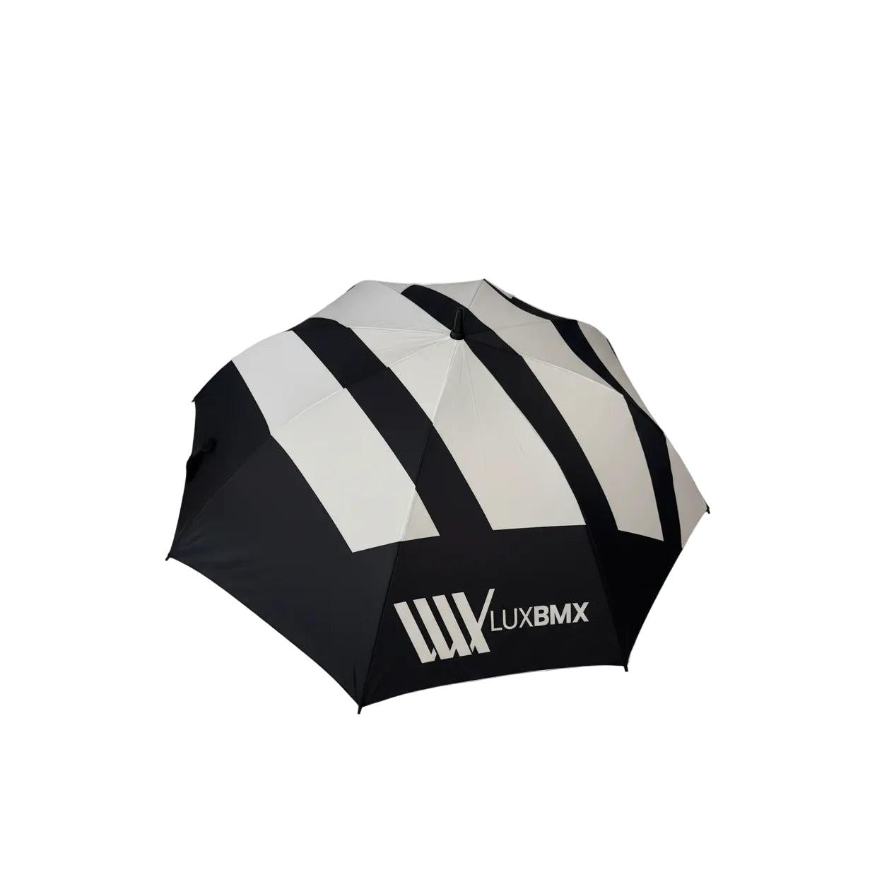 The LUXBMX Race Track Umbrella is black and white with diagonal stripes, a carbon pole, double-stitched seams, and the "LUXBMX" logo on one panel.