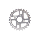 The Radio Axis Sprocket is a silver bicycle chainring with 26 teeth and cutouts, expertly CNC machined from sturdy 6061-T6 alloy, featuring the "RADIO" brand name engraved on its surface.