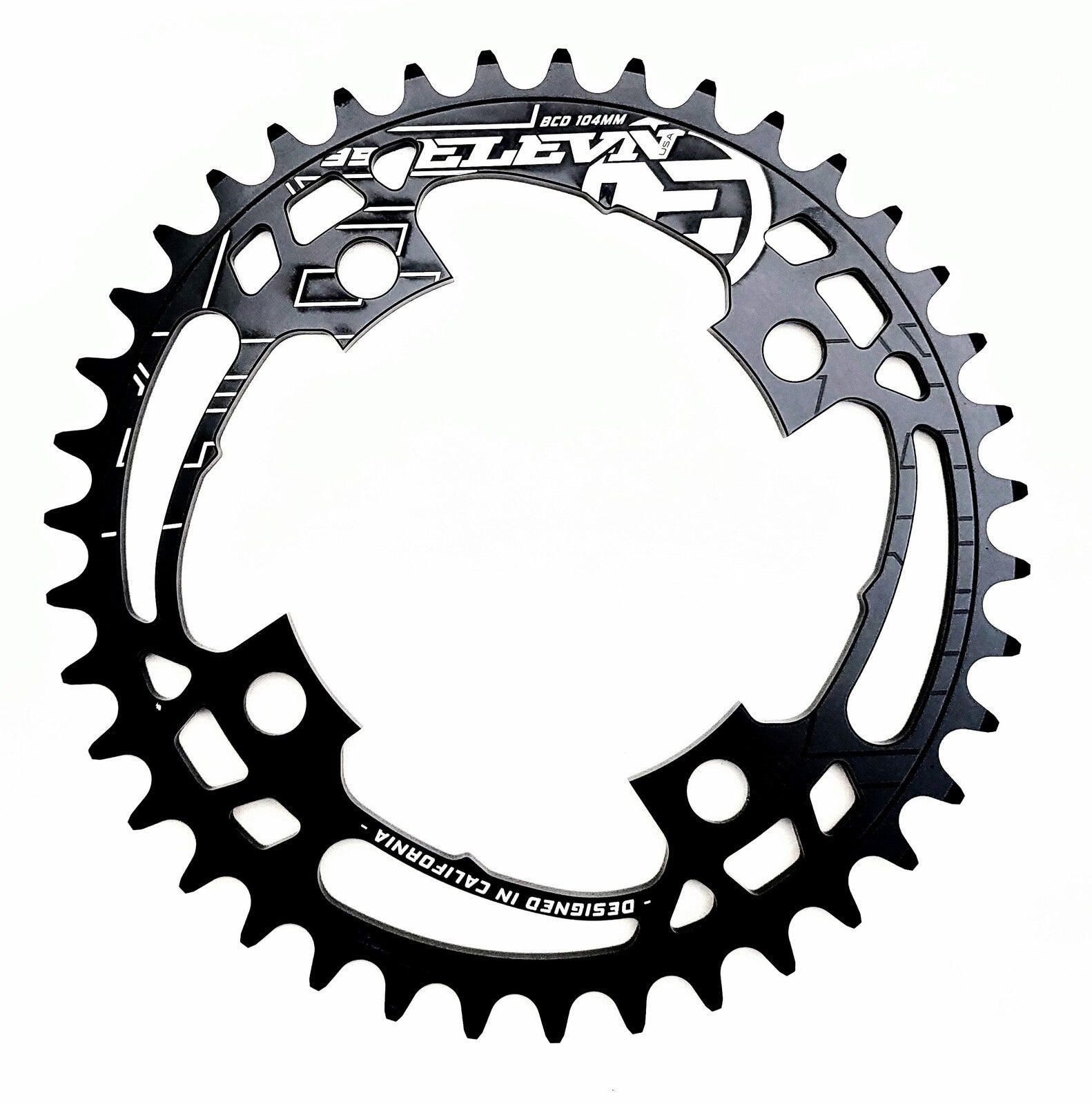 A black Elevn Flow 4 Bolt 104 Chainring with 34 teeth and cut-out details, featuring white branding, is shown on a white background. It’s a CNC race chainring with a 104mm BCD for precise fit and performance.