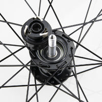 Close-up of the Excess XLC-2 20 x 1.3/8 Alloy Wheel Set 36H hub, displaying attached spokes, axle, and opened bearing assembly against a white background.