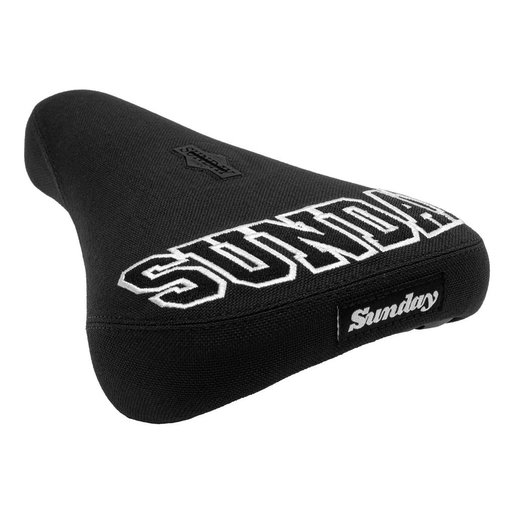 The Sunday Blockhead Pivotal Seat is black with "Sunday" in large white collegiate-style letters on the back and a small "Sunday" label on the side.