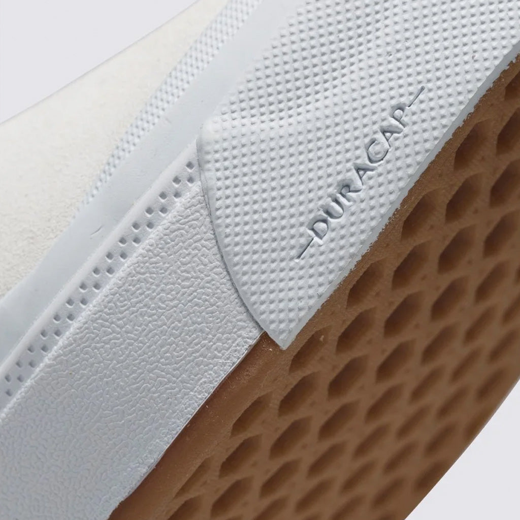 A close up of a white Vans BMX Slip-On Pro shoe with a gum sole, perfect for BMX riders.